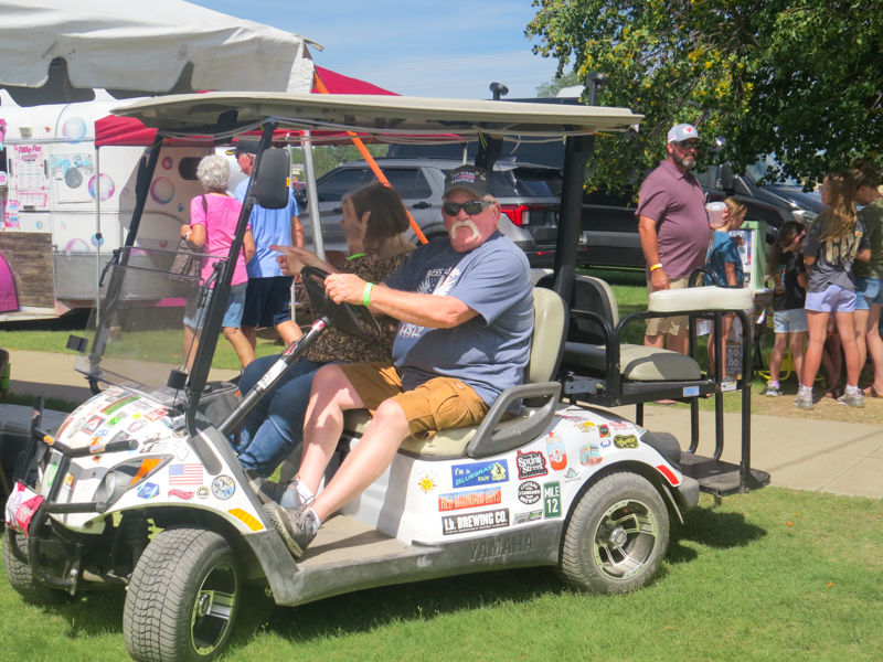 Golf cart huddle at the 2026 Pickin' On The Plains Music Festival - photo © Evan Barnum