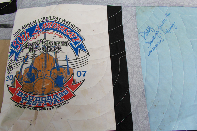 Signed T-shirt quilt given to promoter Mike Wilson by his family at the 2026 Willow Oak Bluegrass Festival - photo © Laura Ridge