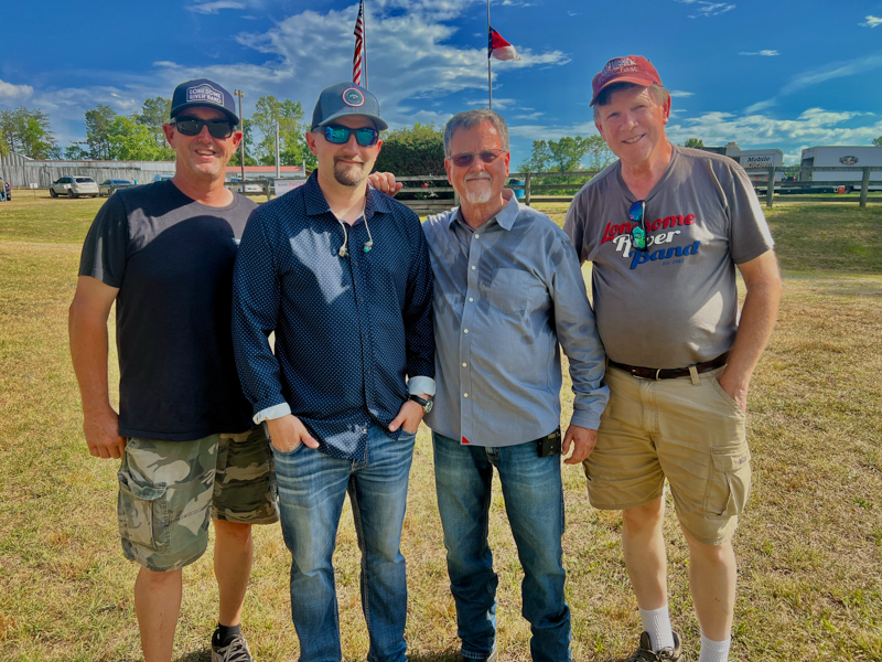 Bluegrass power meeting: Cody Johnson (Camp Springs promoter), Kameron Keller and Mike Hartgrove (Lonesome River Band), and Gary Hatley (Bluegrass Today videographer) at the 2026 Willow Oak Bluegrass Festival - photo © Sandy Hatley