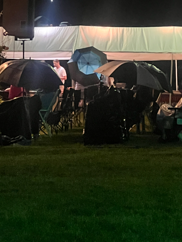 Faithful few enduring the rain before the storm shut down the stage show at the 2026 Willow Oak Bluegrass Festival - photo © Sandy Hatley