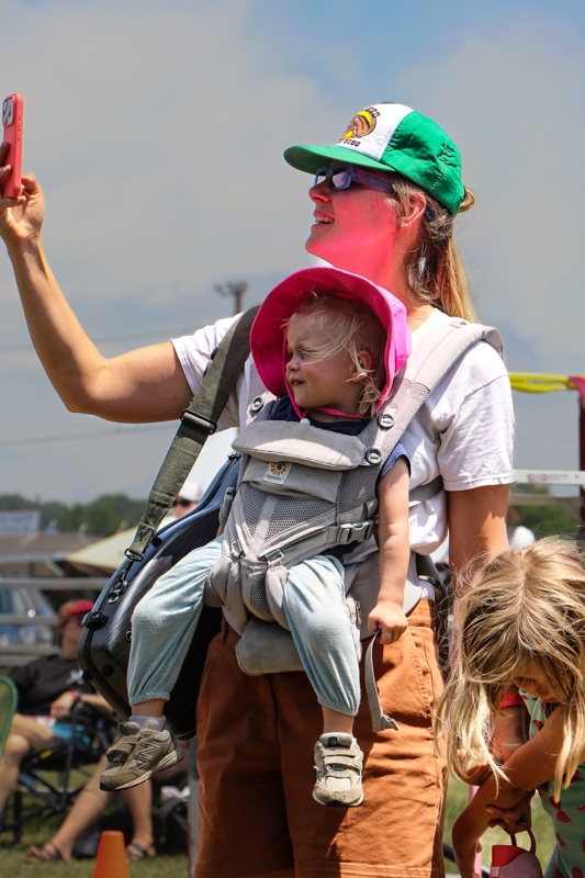 Proud mom videoing child on stage at the 2026 Mount Airy Fiddlers' Convention - photo © G. Nicholas Hancock