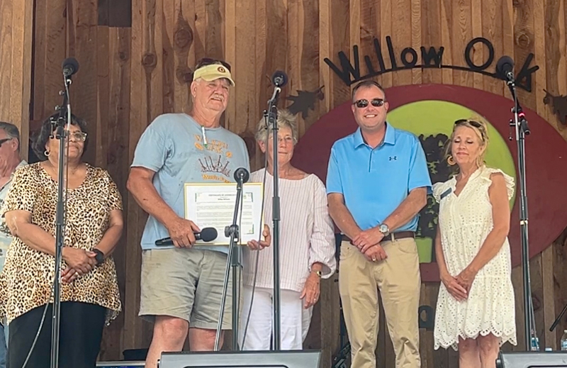 Mike Wilson flanked by Roxboro mayor and representatives of the Person County Tourism Development Authority at the 2026 Willow Oak Bluegrass Festival - photo © Sandy Hatley