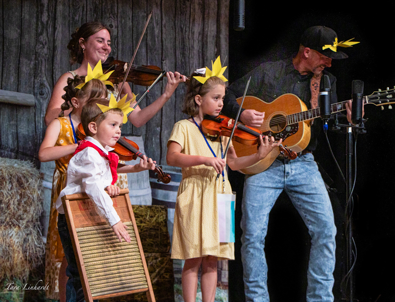 Certified Contestants doing You Are My Sunshine at the 2026 National Oldtime Fiddlers' Contest & Festival - photo © Tara Linhardt