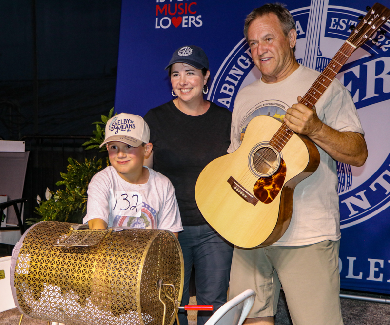 Drawing the winning ticket for the Asher Hurley Memorial Scholarship guitar  at the 2026 Abingdon Fiddlers' Convention - photo © G. Nicholas Hancock