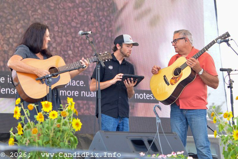 Sound man Elijah Doty confers with Kenny & Amanda Smith at the 2026 Industrial Strength Summer Fest - photo © Bill Warren