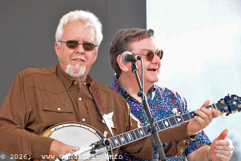 Ben Greene and Joe Mullins try some three-handed banjo playing with Lorraine Jordan & Carolina Road at the 2026 Industrial Strength Summer Fest - photo © Bill Warren