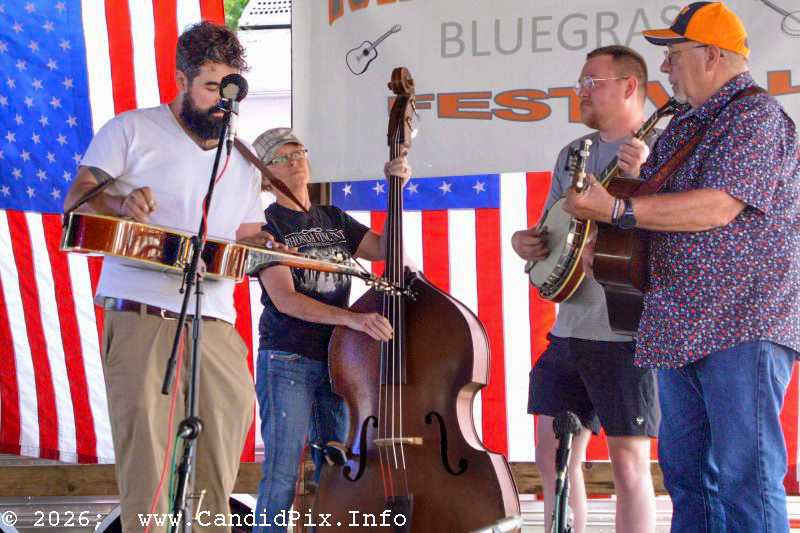 Lisa Loutit on bass, Zach Collier on banjo, and Jim Fox guitar in the band scramble at the 2026 Marshall Bluegrass Festival - photo © Bill Warren