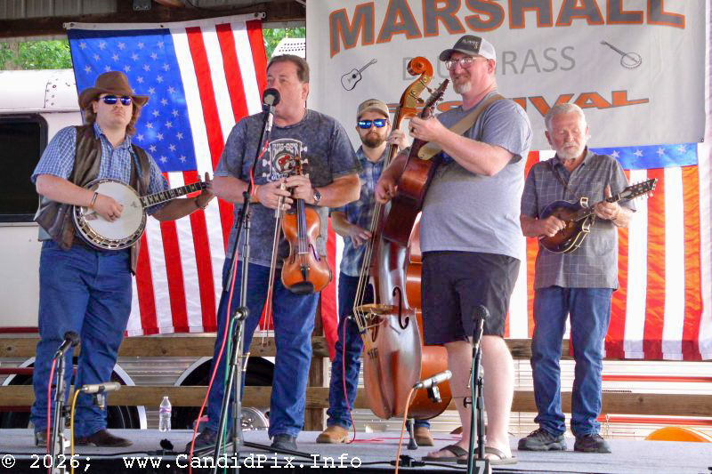 Ian Ross, Steve Day, Chad Phelps, Tony Zapolnik, and Ben Crofoot in the band scramble at the 2026 Marshall Bluegrass Festival - photo © Bill Warren