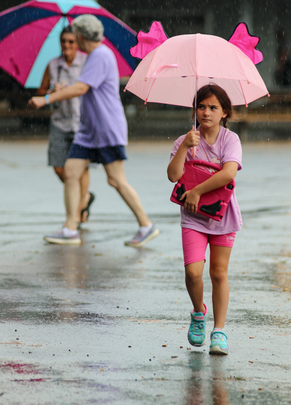 Girl with umbrella at the 2026 Alleghany County Fiddlers' Convention - photo © G. Nicholas Hancock