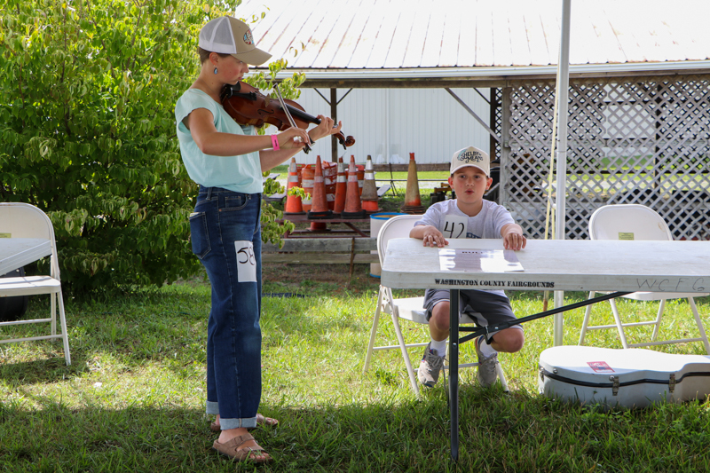 Hollace Oakes and Carrson Blankenship rehears the National Anthem at the 2026 Abingdon Fiddlers' Convention - photo © G. Nicholas Hancock