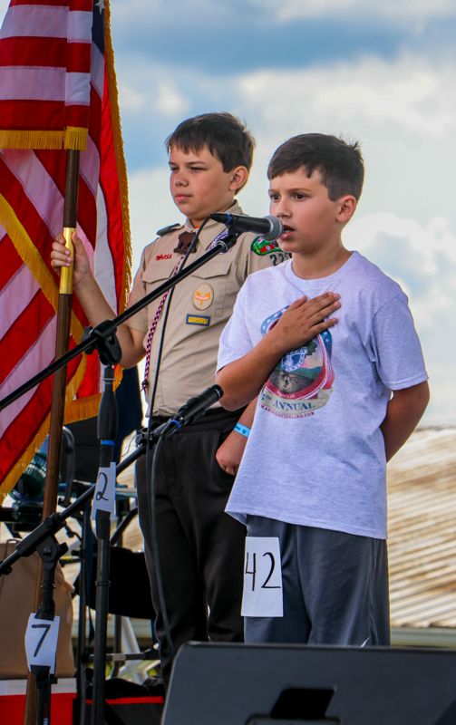 Wes Berry hold the flag as Carrson Blankenship sings the National Anthem at the 2026 Abingdon Fiddlers' Convention - photo © G. Nicholas Hancock