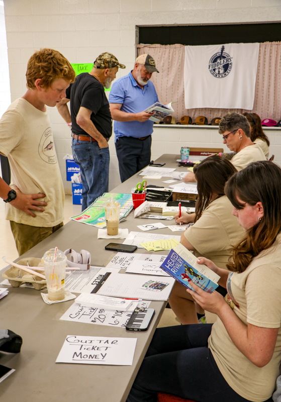 William Boggs and the Kessinger brothers registering for competition at the 2026 Abingdon Fiddlers' Convention - photo © G. Nicholas Hancock