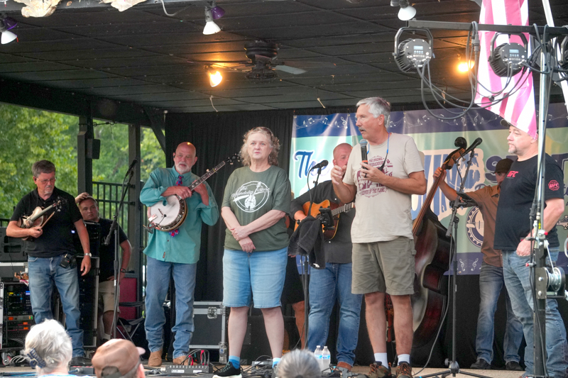 Promoters Lorraine Jordan and Allen Dyer getting ready to introduce Lonesome River Band at the 2026 North Carolina State Bluegrass Festival in Cherokee - photo © Jeff Lahr