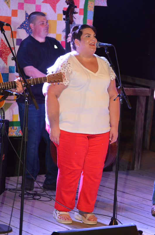 Promoter Moochie Hart sings one with Throwdown Thursday at the 2026 Lake Cumberland Bluegrass Festival - photo © Roger Black