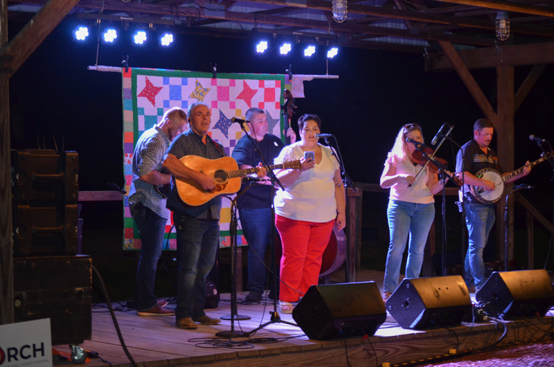 Promoter Moochie Hart sings one with Throwdown Thursday at the 2026 Lake Cumberland Bluegrass Festival - photo © Roger Black