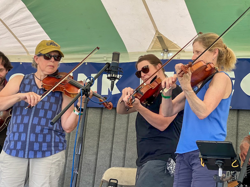 Fiddlers Three (Ellen Carlson, Melissa Bragdon Caron and Kathy Zimpfer Sommer) at the 2026 Podunk Bluegrass Music Festival - photo © Dale Cahill