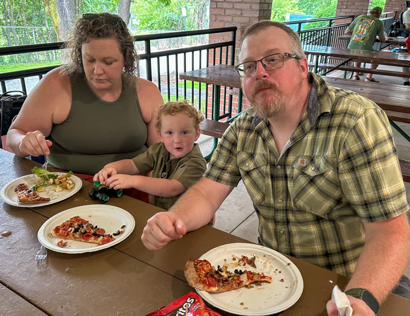 MacKenzie with Andrew II and Andy, enjoying their pizza, at Bob Artis' 80th birthday celebration (7/26/26) - photo © Karen Artis