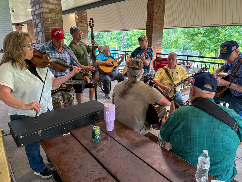Linda (Cochran) Hamrick, with brothers Jim on guitar and Bert on banjo - the Cochran Family, honored members of West Virginia's Country Music Hall of Fame. Also on guitar (light blue shirt) is "Turbo" Bob Turbanic, Director and Founder of the Wheeling Park High School Bluegrass Band at Bob Artis' 80th birthday celebration (7/26/26) - photo © Karen Artis