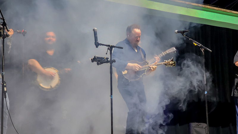 Jesse Brock with Authentic Unlimited engulfed with smoke at the 2026 Camp Springs Labor Blue Grass Festival - photo © Laura Tate Photography