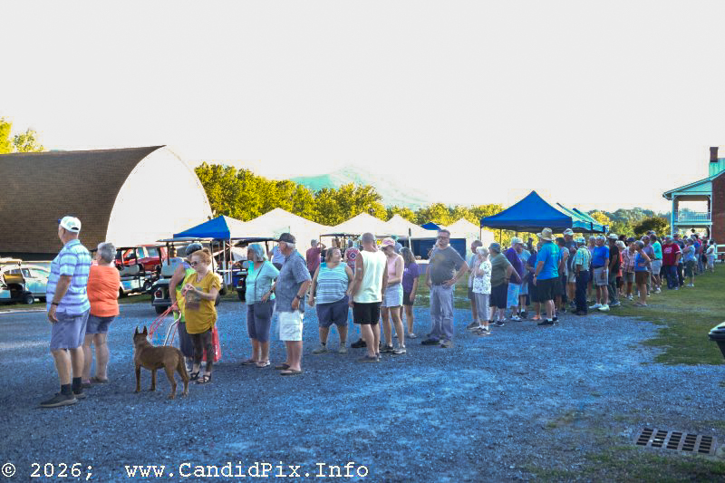 Lining up for a pot luck dinners at the 2026 Nothin' Fancy Bluegrass Festival - photo © Bill Warren