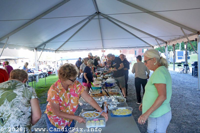 Lining up for a pot luck dinners at the 2026 Nothin' Fancy Bluegrass Festival - photo © Bill Warren