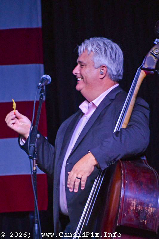 Mickey Harris gets a tiny rubber chicken for his birthday at the 2026 Nothin' Fancy Bluegrass Festival - photo © Bill Warren