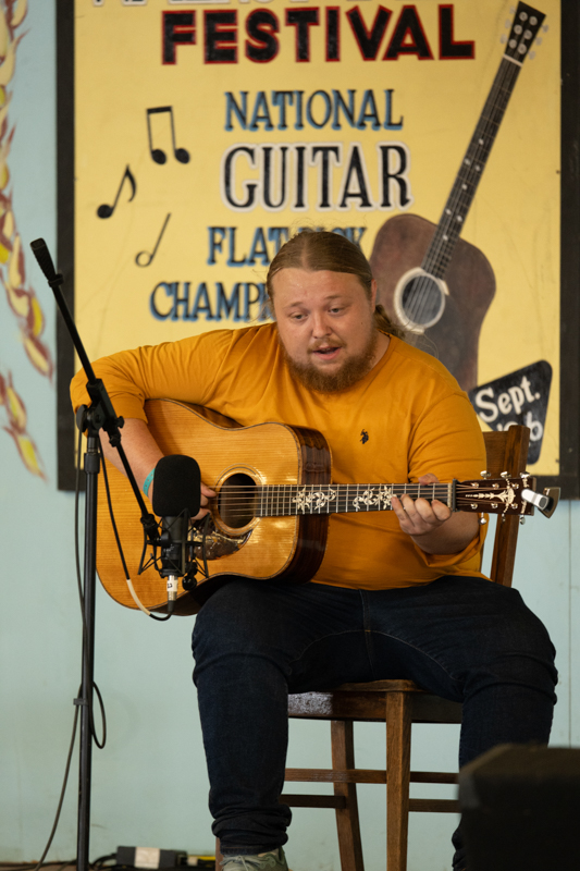 Jakob Thomas competing in the National Flat Pick Guitar category, 54th Annual Walnut Valley Festival, Friday, September 18th, 2026. Winfield, Kansas. Photo by Jeromie Stephens © 2026