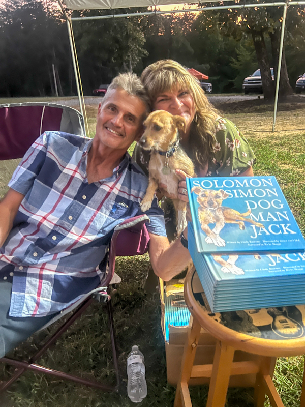 Terry Eldridge and Cindy Baucom with Simon, subject of her book on Lewy Body Dementia at the 2026 Camp Springs Labor Day Blue Grass Festival - photo © Sandy Hatley