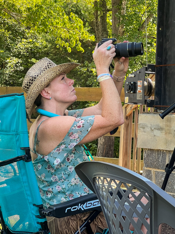 Laura Ridge shooting the stage at the 2026 Camp Springs Labor Day Blue Grass Festival - photo © Sandy Hatley