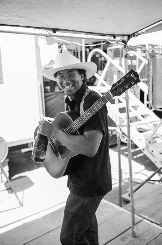 Isaiah Sibi, guitarist in The Lost Keys, leaving Stage 1, 54th Annual Walnut Valley Festival, Wednesday, September 17th, 2026. Winfield, Kansas. Photo by Jeromie Stephens © 2026 