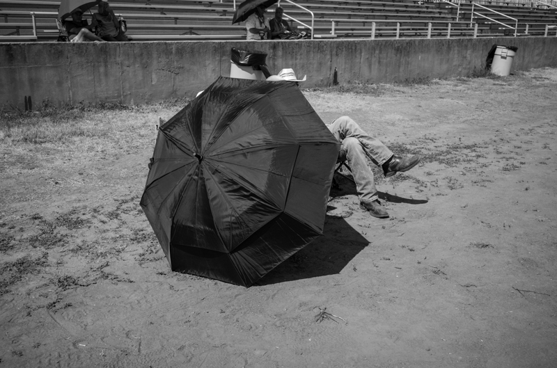Seeking shade in front of Stage 1, 54th Annual Walnut Valley Festival, Thursday, September 18th, 2026. Winfield, Kansas. Photo by Jeromie Stephens © 2026