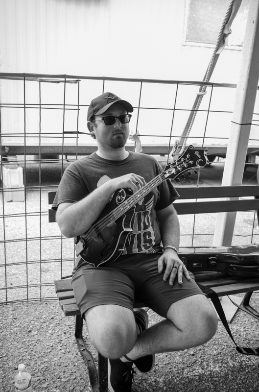Anthony Howell of Kosciusko, Mississippi waiting for the National Mandolin competition to begin. Howell went on to win this category and placed 2nd in the National Flat Pick Guitar competition. 54th Annual Walnut Valley Festival, Thursday, September 18th, 2026. Winfield, Kansas. Photo by Jeromie Stephens © 2026