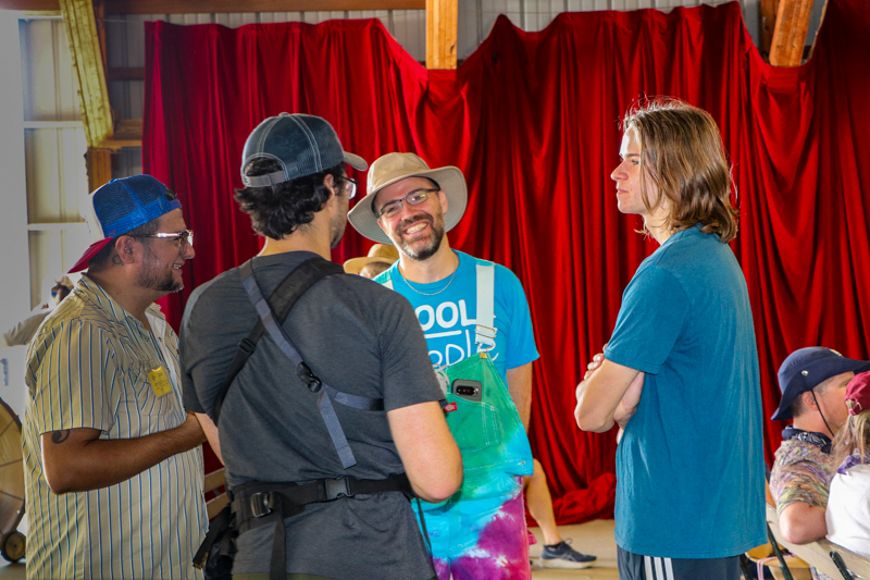 Marcel Ardans and Rob Gourley, documentary filmmakers, talk with Scott and Oscar Caudell at the 2026 Walnut Valley Festival - photo © G. Nicholas Hancock