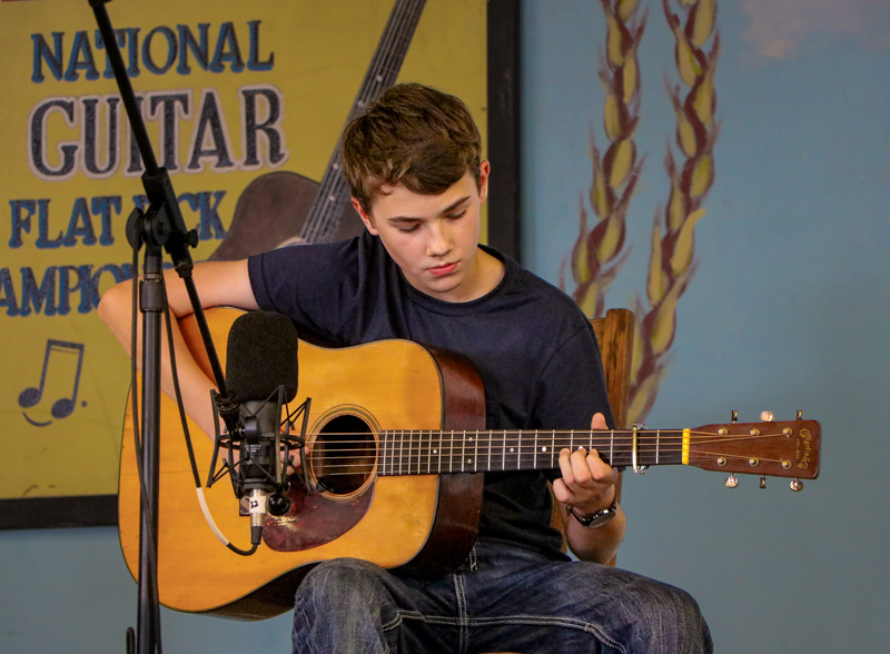 Sam Schoonover in the National Flat Pick Guitar competition at the 2026 Walnut Valley Festival - photo © G. Nicholas Hancock