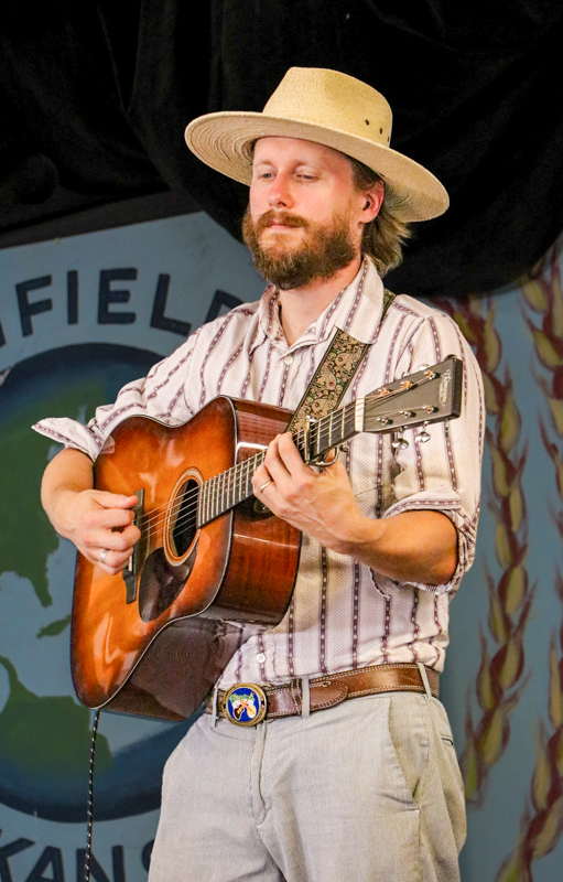 Sam Wharton with Songs From The Road Band at the 2026 Walnut Valley Festival - photo © G. Nicholas Hancock