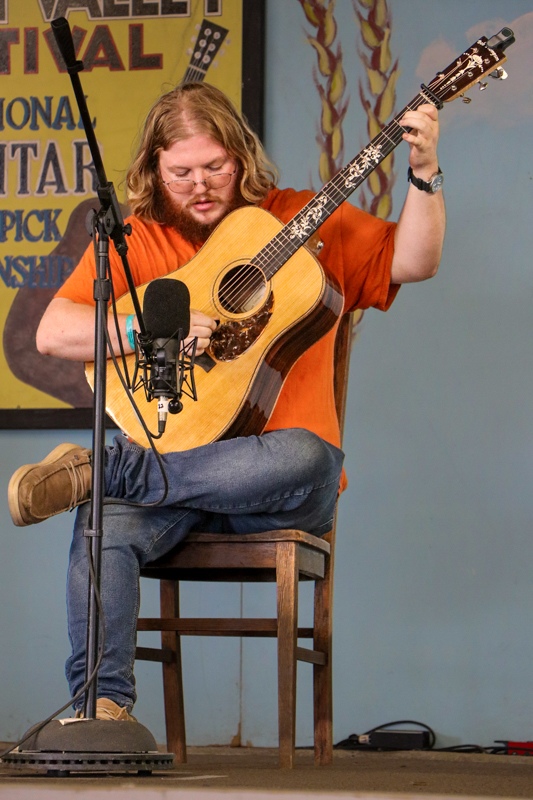 Silas Powell in the National Flat Pick Guitar competition at the 2026 Walnut Valley Festival - photo © G. Nicholas Hancock