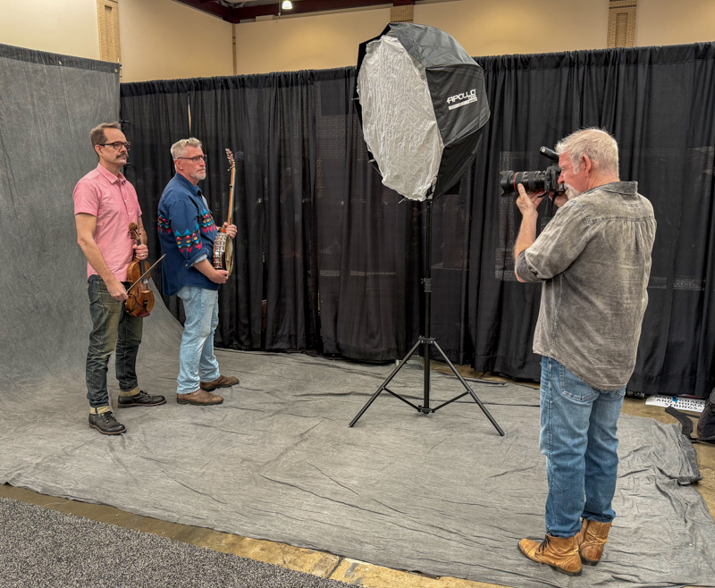 Jeff Fasano photographing John Showman and Chris Coole of the Lonesome Ace Stringband at the World of Bluegrass Exhibit Hall - photo © Elizabeth Loring