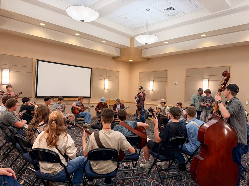 Sam Bush jamming with Kids on Bluegrass participants at World of Bluegrass '26 - photo © Amanda Schwartz