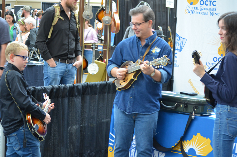Young pickers jamming with Scott Napier at World of Bluegrass '26 - photo © Roger Black