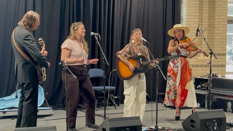 Ben Wright, Celia Wordsmith, Anya Hinkle, and Leona Tokutake perform at The Bluegrass Scene in Japan panel at World of Bluegrass 2026