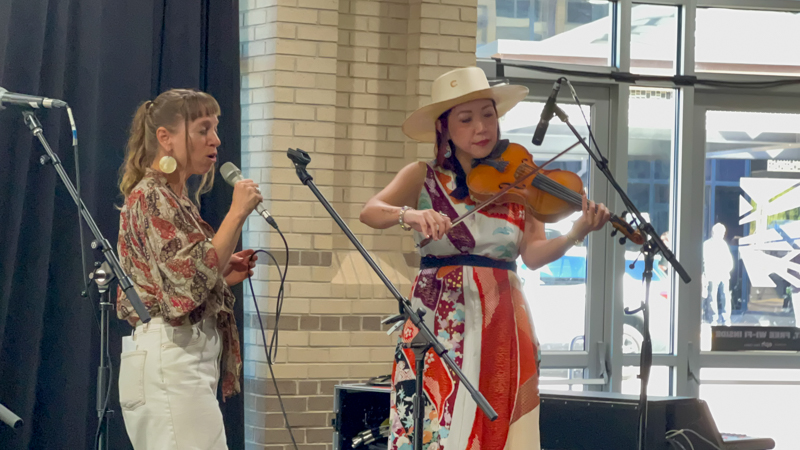 Anya Hinkle and Leona Tokutake perform at The Bluegrass Scene in Japan panel at World of Bluegrass 2026