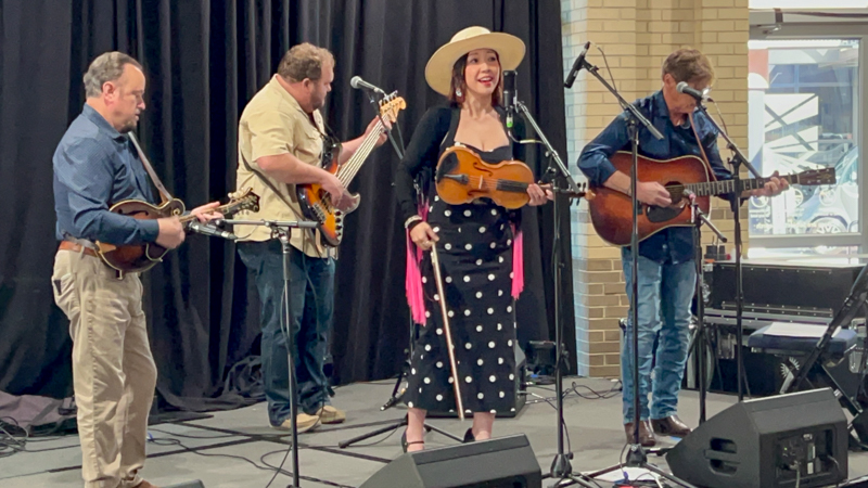 Jesse Brock, Eli Johnston, Leona Tokutake, and Richard Bennett perform at The Bluegrass Scene in Japan panel at World of Bluegrass 2026