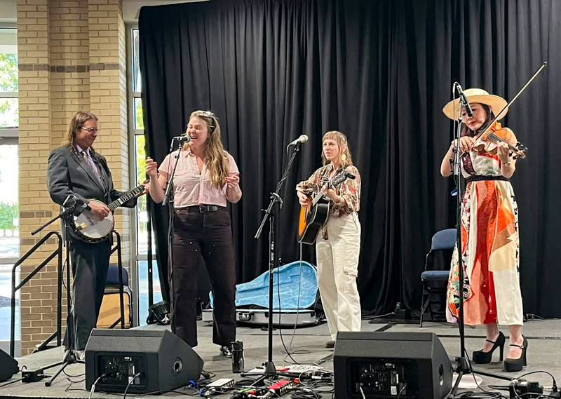 Ben Wright, Celia Wordsmith, Anya Hinkle, and Leona Tokutake perform at The Bluegrass Scene in Japan panel at World of Bluegrass 2026