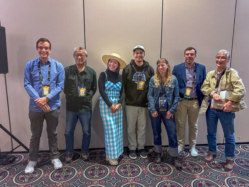 The Bluegrass Scene in Japan panel at World of Bluegrass 2026: Tim Burns, Hideaki Mizuno, Leona Tokutake, Chad Andrew Harris, Anya Hinkle, Zach Dressel , and Toshio Watanabe