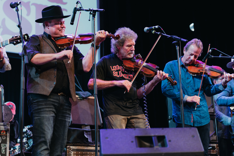 Jim VanCleve, Sam Bush, and Stuart Duncan throw down triple fiddles at the 2026 National Fiddler Hall of Fame induction - photo © Jamey Booher Photography