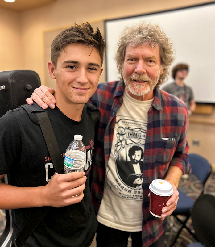 Peter Trakimowicz with Sam Bush at World of Bluegrass '26 - photo © Amanda Schwartz
