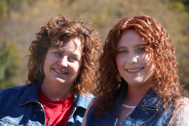 Olivia Jo with her mom at the 2026 Smoky Mountains Bluegrass Festival - photo © Jeff Lahr