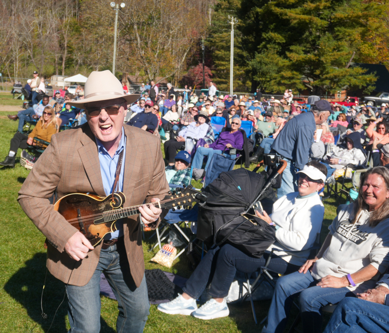 Darrell Webb with Appalachian Road Show goes into the audience at the 2026 Smoky Mountains Bluegrass Festival - photo © Jeff Lahr